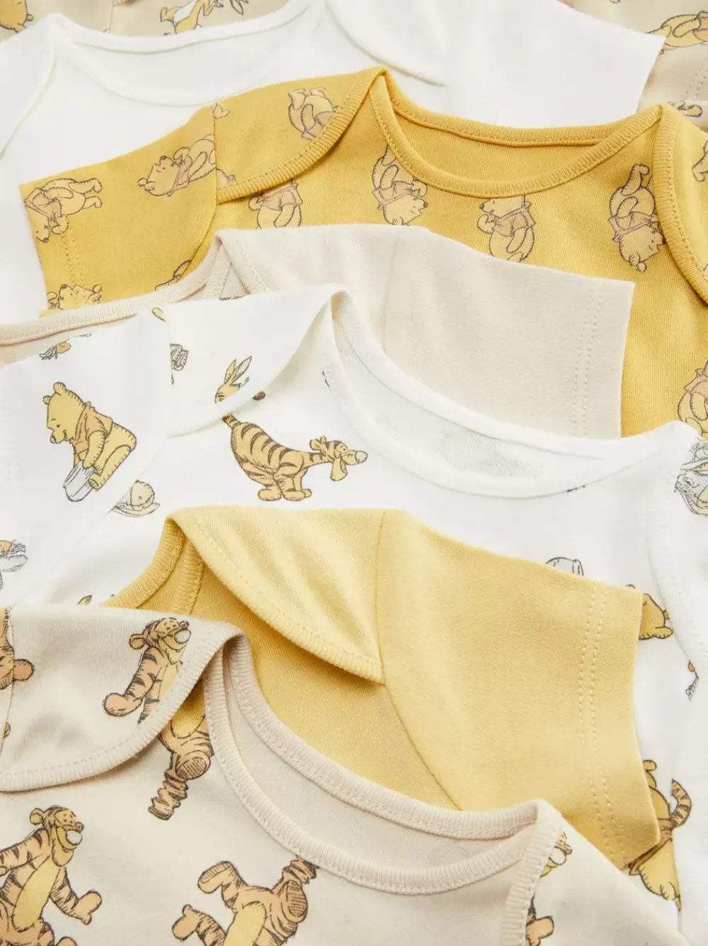 Primark Body I Koszulki Bez Rękawów|Body I Koszulki Bez Rękawów<Śpioszki z motywem Kubusia Puchatka Disneya, 7 szt.